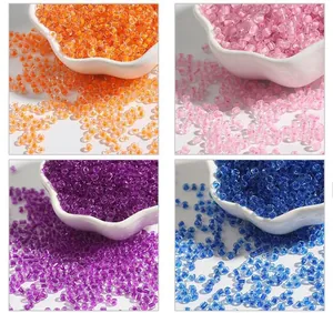 Macro detail of 2-4mm colorful glass seed beads for various DIY jewelry making projects.