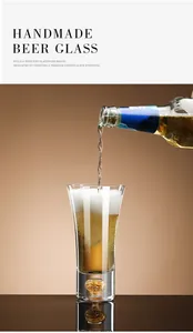 Close-up of beer pouring into a handmade crystal glass with decorative gold leaf base