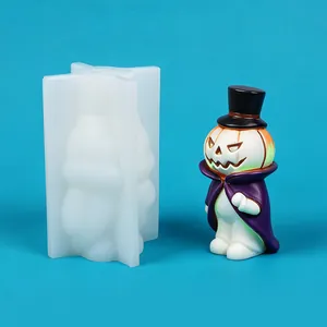 Detail view of Halloween pumpkin gentleman silicone mold next to finished purple cloak figure.