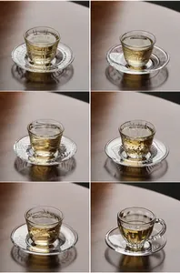 Exquisite collection of transparent glass tea cups with diverse relief patterns and saucers