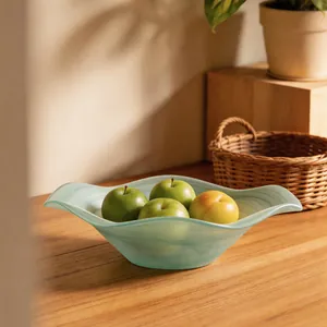 Elegant frosted green glass fruit bowl with wavy flower edges and marble ink patterns