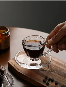 Detail shot of a premium heat-resistant glass teacup set on a rustic wooden board.