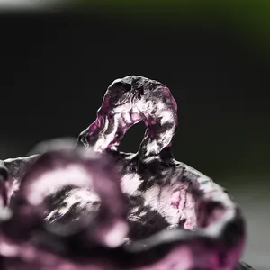 Detailed macro view of handmade purple Liuli glass incense burner with zen texture