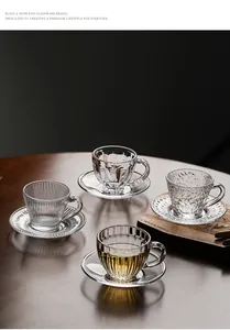 Detailed view of four heat-resistant glass tea cups with diverse embossed textures