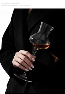Detailed view of an elegant trumpet-shaped crystal cocktail glass held in hand