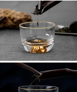 Close-up of Japanese glass teacup featuring a handcrafted gold mountain base detail.