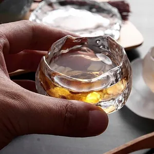 Close-up of a Japanese style hand-blown glass tea cup with ice texture.