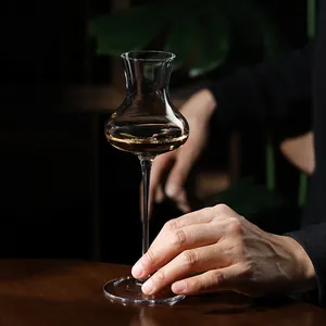 Elegant crystal trumpet-shaped glass for champagne and cocktails on dark wooden table