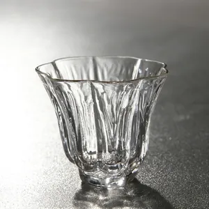 Hand-blown clear glass tea cup with elegant fluted design for minimalist Kung Fu tea sets.