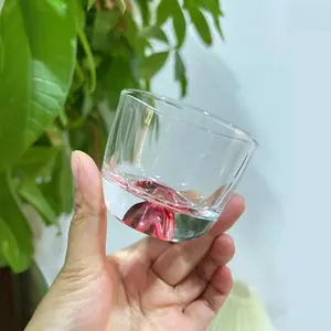 Japanese style clear glass cup with red mountain base design for tea or whiskey