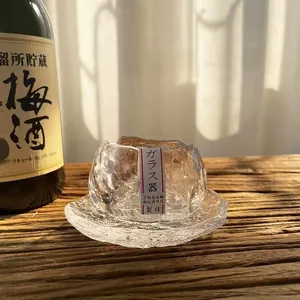 Detail of a Japanese hammered glass tea cup featuring a textured ice-like finish