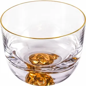 Japanese style clear glass tea cup featuring hand-painted gold rim and gold mountain base