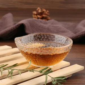 Detailed view of handcrafted hammered texture on a clear glass Kung Fu tea cup
