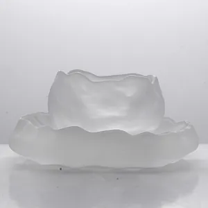 Japanese style frosted glass tea cup with irregular wavy edges and matching saucer set