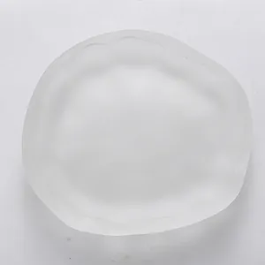 Detailed top view of a minimalist Japanese frosted glass saucer with irregular edges