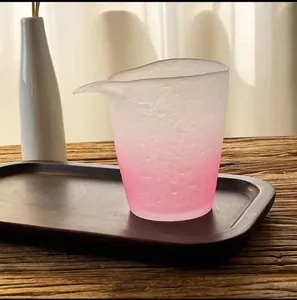 Macro view of a pink frosted glass fairness cup featuring a gradient color and textured finish