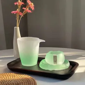 Elegant frosted green gradient glass tea set including a pitcher and small cup on tray