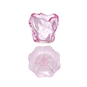 Elegant pink textured glass tea cup with flower-shaped saucer set on white background