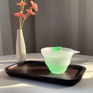 Elegant frosted green gradient glass gaiwan tea set displayed on a rustic wooden tray