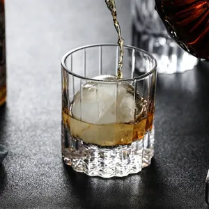 Premium hand-cut Edo Kiriko crystal whiskey glass with a round ice ball on a dark table