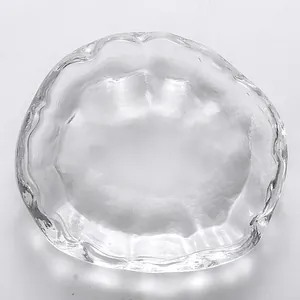 Macro view of clear Japanese style glass tea cup with hammered texture and wavy rim