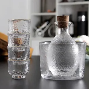 Elegant Japanese hammer pattern glass sake set including warmer pot and four cups