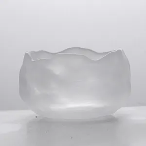 Detailed view of a Japanese frosted glass tea cup with irregular organic edges
