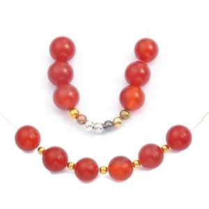Set of red round beads and metallic multi-color spacer beads for DIY jewelry making.