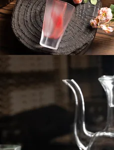Close-up of a minimalist heat-resistant frosted glass tea cup with red ribbon pattern
