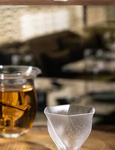 Close-up of handmade bubble crystal glass cup with unique frosted starry pattern