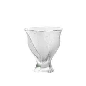 Handmade crystal glass tea cup with seeded bubble texture and a flower-shaped flared rim