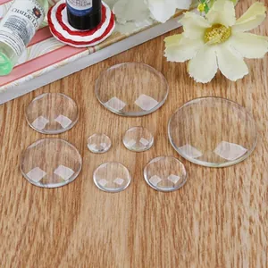 Detailed view of various sizes of transparent round glass cabochons for DIY jewelry