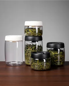Set of professional vacuum glass storage jars for tea leaves on a wooden table
