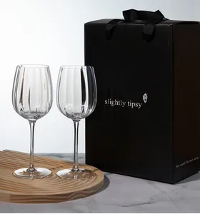 Close-up of crystal wine glasses with vertical stripes and black gift box packaging set