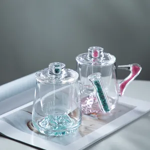 Elegant double-walled glass coffee mugs with mountain base and colorful stone handles
