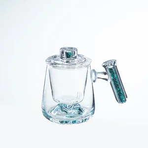 High-end glass tea mug with mountain base and turquoise stone filled handle