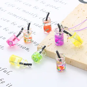 Detailed macro view of colorful mini fruit juice bottle pendants for DIY jewelry