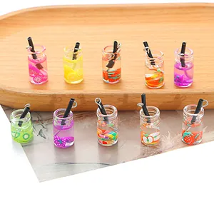 Detailed macro view of miniature colorful fruit bottle charms for DIY jewelry making