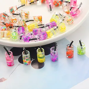 Close-up of colorful miniature fruit tea glass bottle pendants for DIY jewelry making