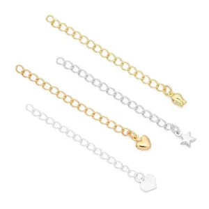 Close-up view of gold and silver jewelry extension chains with various charm shapes