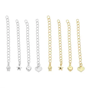 Detailed view of 14K gold and silver extender chains with heart and star charms.