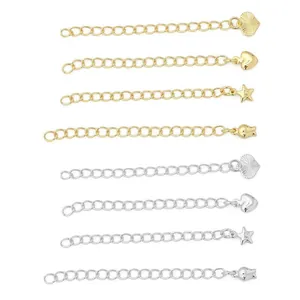 Detailed view of assorted 14K gold and silver plated jewelry extension chains with charms.