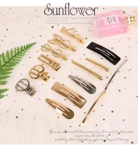 Detailed view of assorted gold and black DIY hair clips in various geometric shapes