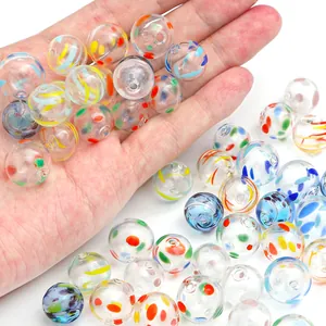 Detailed macro view of colorful hand-painted hollow glass bubble beads for DIY jewelry