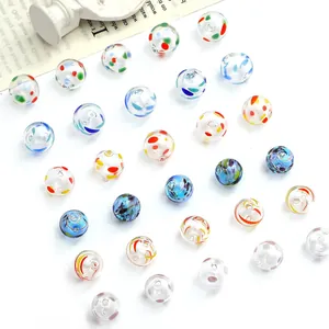 Close-up macro view of colorful hand-painted hollow lampwork glass beads for DIY jewelry