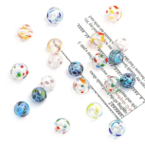 Close-up of hand-painted hollow glass bubble beads with colorful drip oil patterns