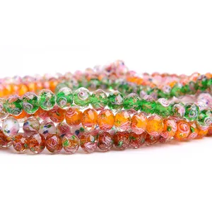 Detail view of faceted lampwork glass beads with internal floral patterns for DIY jewelry