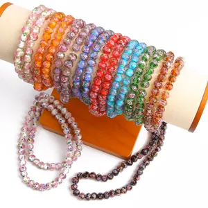 Detail view of colorful faceted lampwork wheel beads for DIY jewelry craft projects.