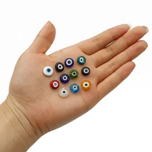 60pcs assorted colorful evil eye glass beads held in hand for jewelry DIY projects