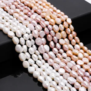 Detailed close-up of natural baroque freshwater pearls in white pink and peach shades